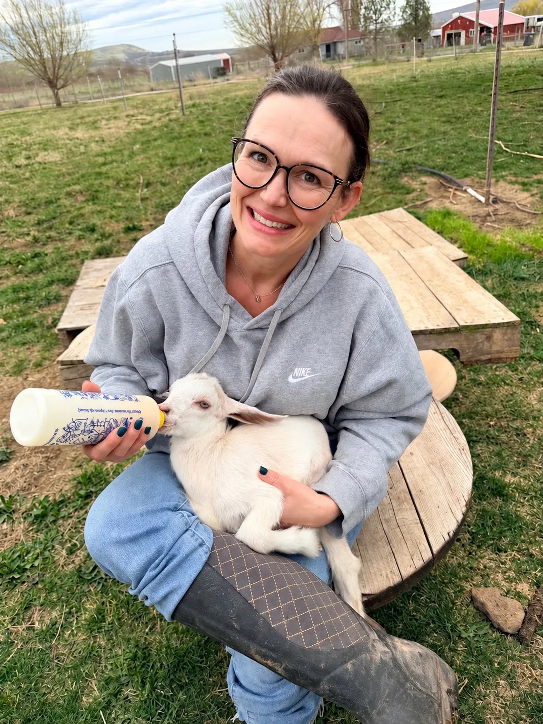 Rebecca Sullivan with baby goat Dolly on her 5-acre homestead in Tri-Cities, WA